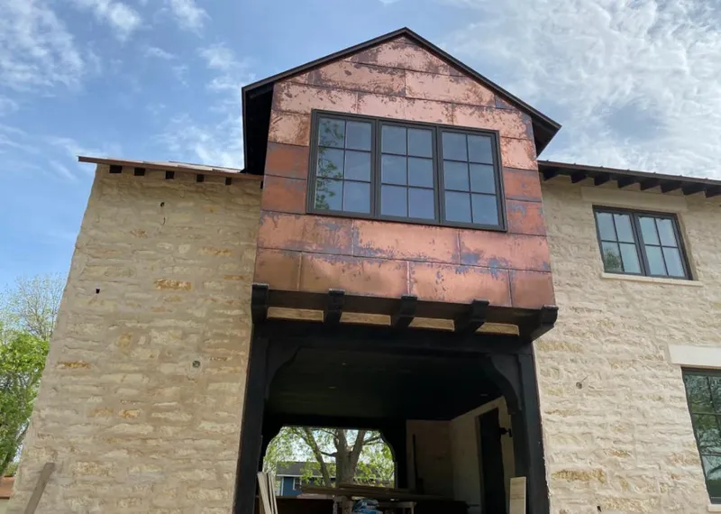 Copper metal panel facade on a stone building for Metal Roof Coating in Eastpointe